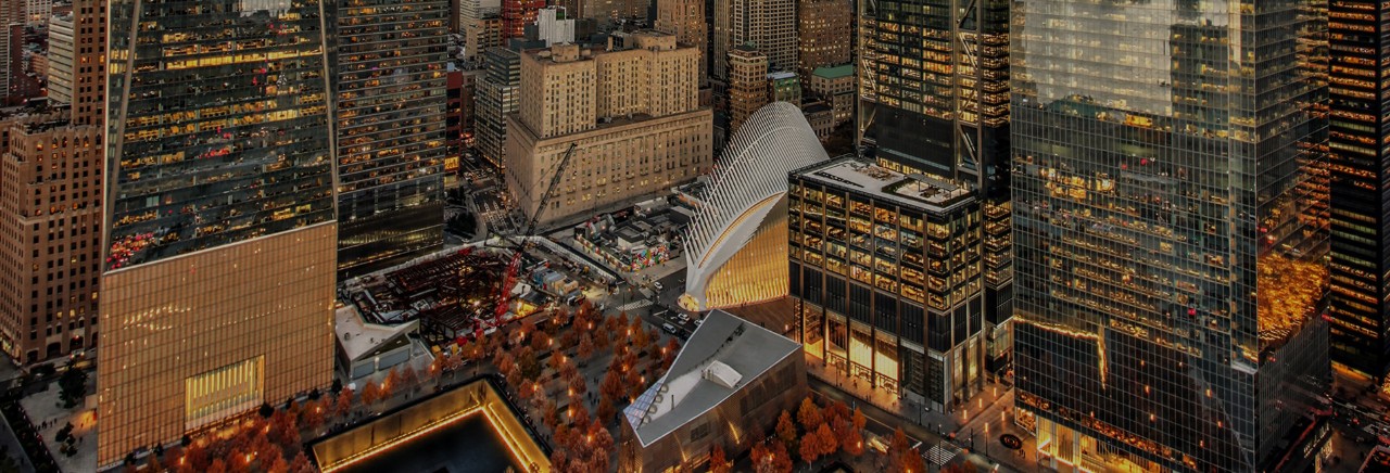 A view of One World Trade Center, the Oculus, Three World Trade Center, and Four World Trade Center at dusk.